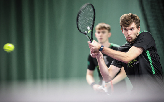 Student playing tennis