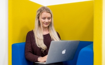An image of a student studying and working at a laptop.