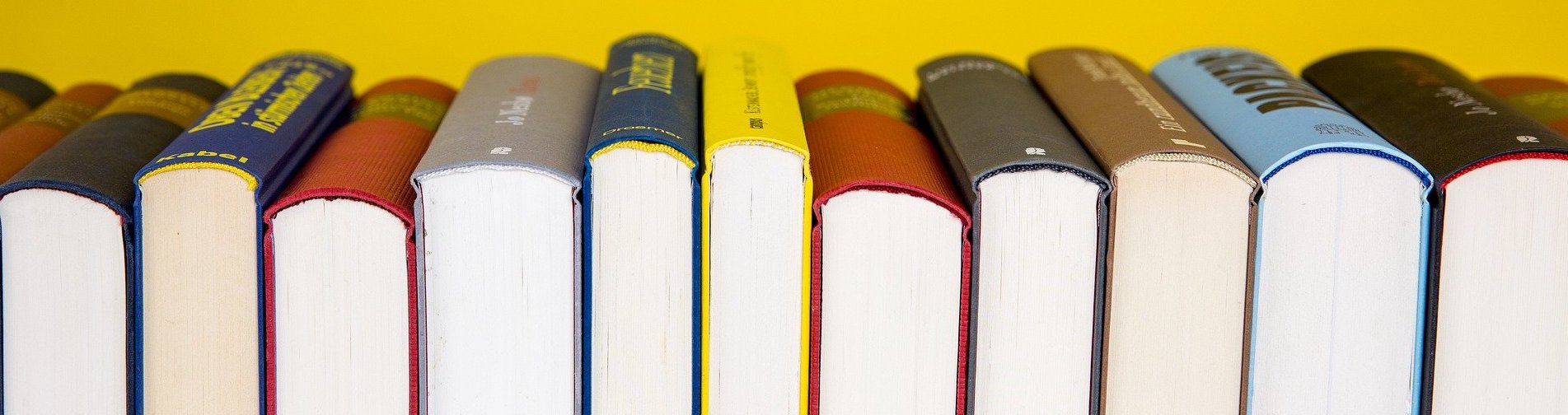 Row of books on yellow background
