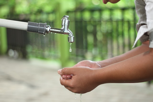 hands under a dripping tap