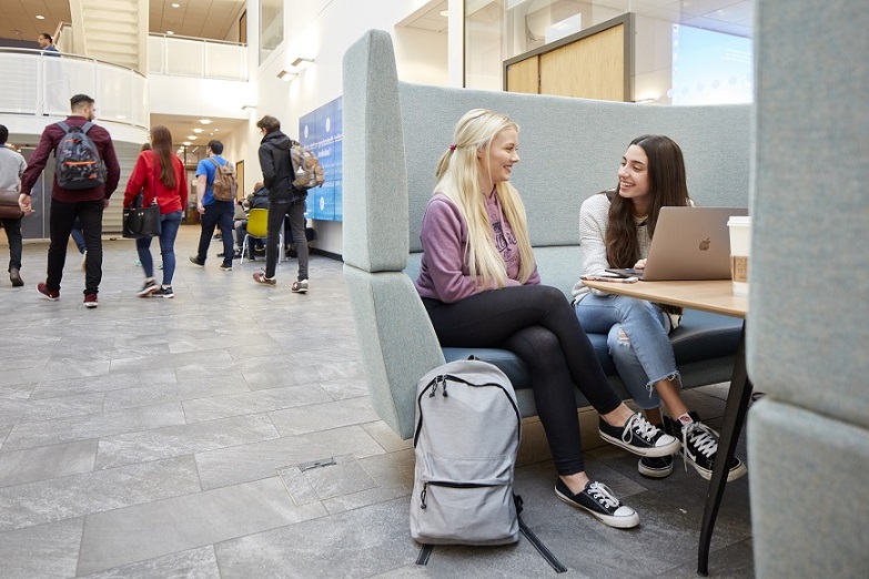 Two students chatting in Bay Campus