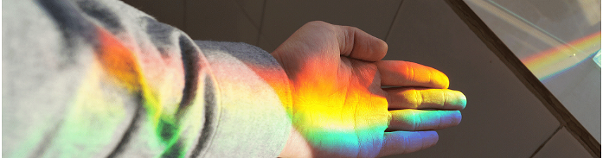Rainbow reflected on an outreached hand