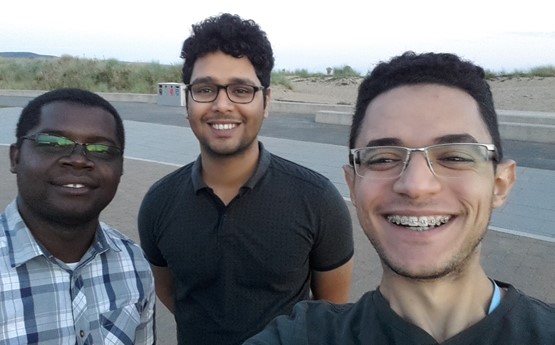 Ahmed Ibrahim (on the right of the photo) takes a selfie with two of his best friends on Bay Campus beach.