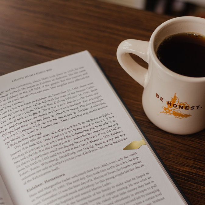 Image of an open book and a coffee mug