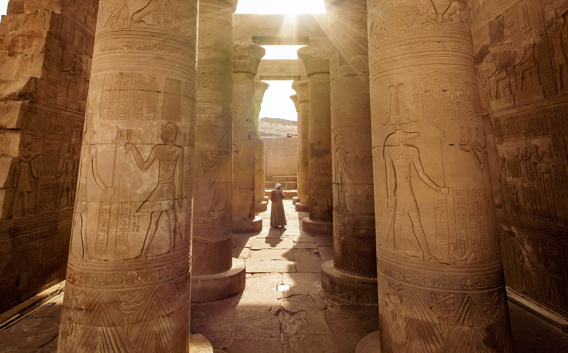 Image of Egyptian columns and a person in the middle