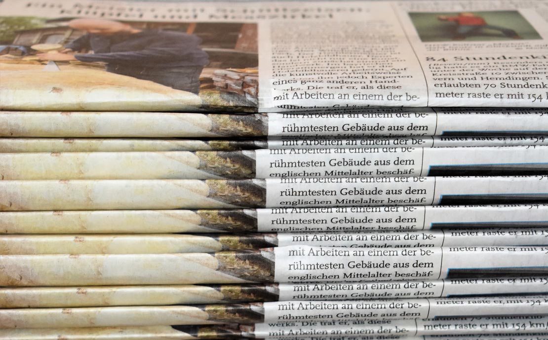An image of a stack of newspapers