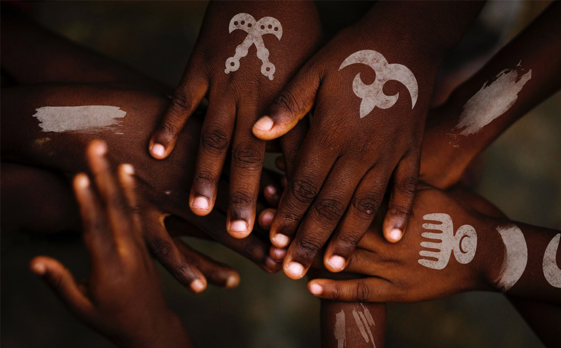 Image of hands with painted symbols on them 