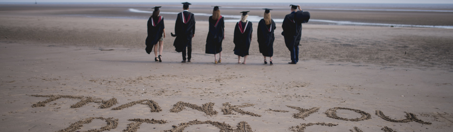 students on the beach at graduation