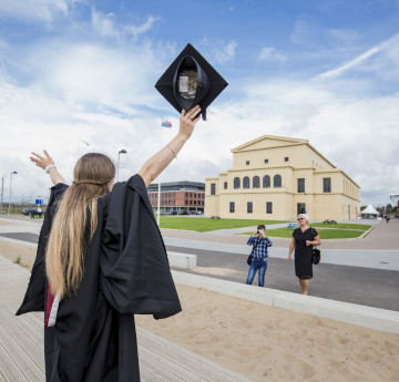 girl with graduation hat in the air