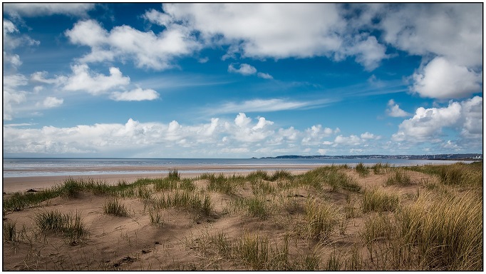 sand dunes and beach on a sunny day at crymlyn burrows