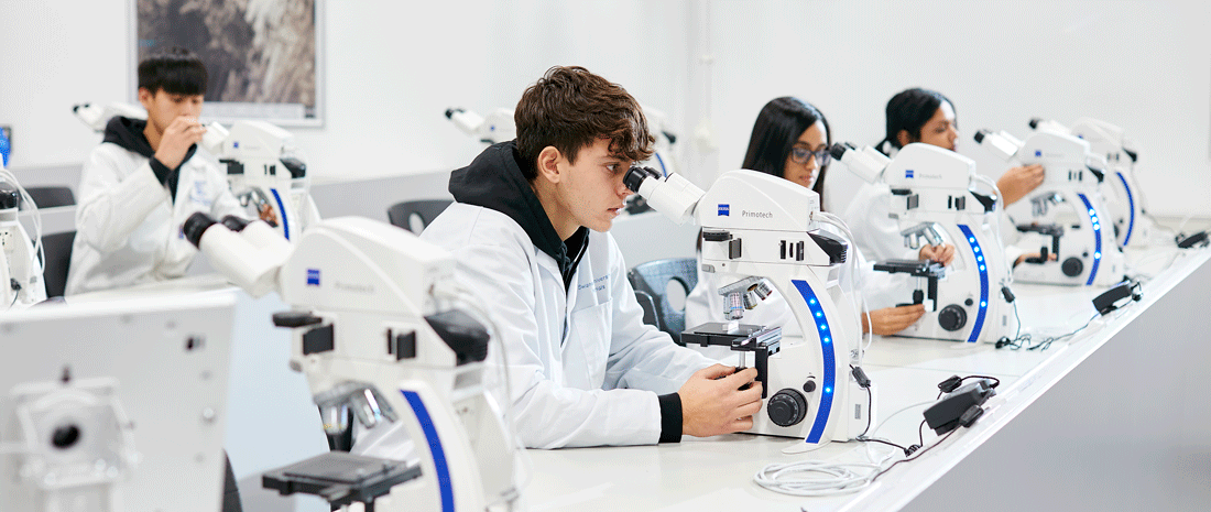 Students looking through microscope in lab