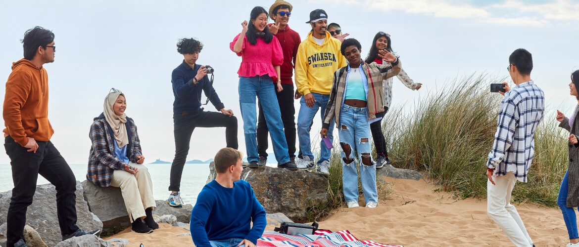 students on bay campus beach