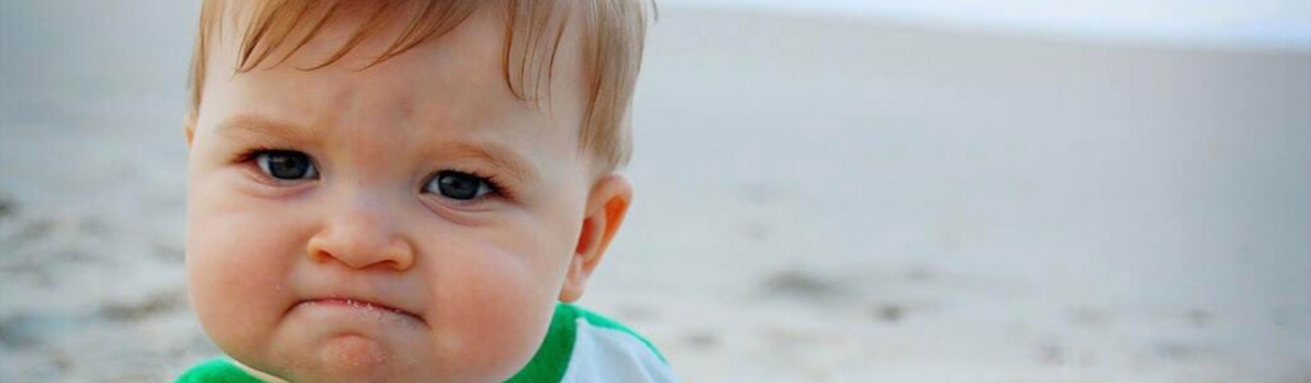 A popular meme showing a baby triumphantly clenching a fist full of sand.