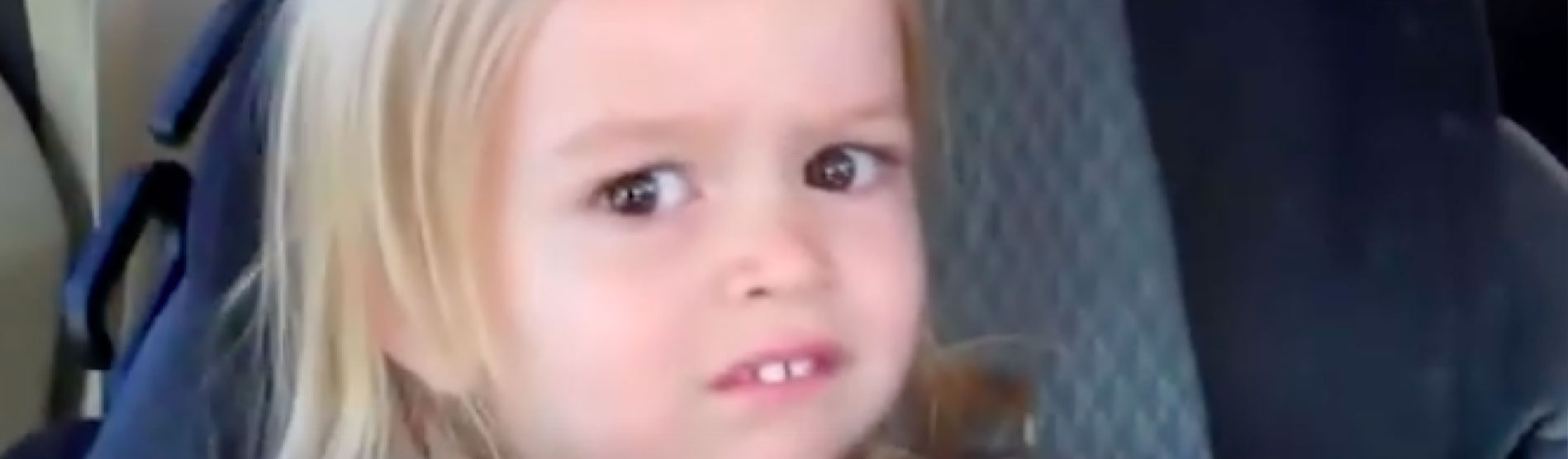 A popular meme showing a child in a car seat giving side eye or looking nervous.