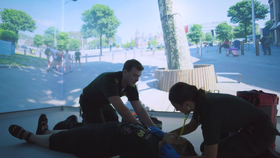 Paramedic students in street simulation with patient
