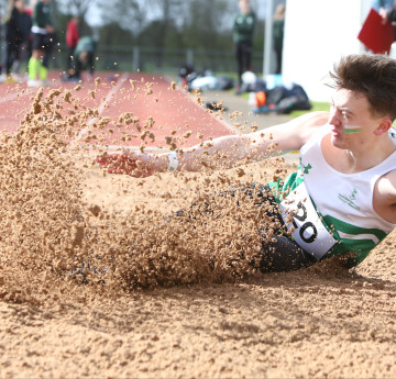 Student landing in sand pit for longjump