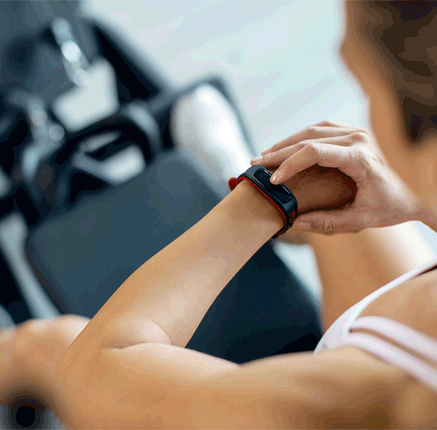 close up of athlete using fitness tracker wristwatch