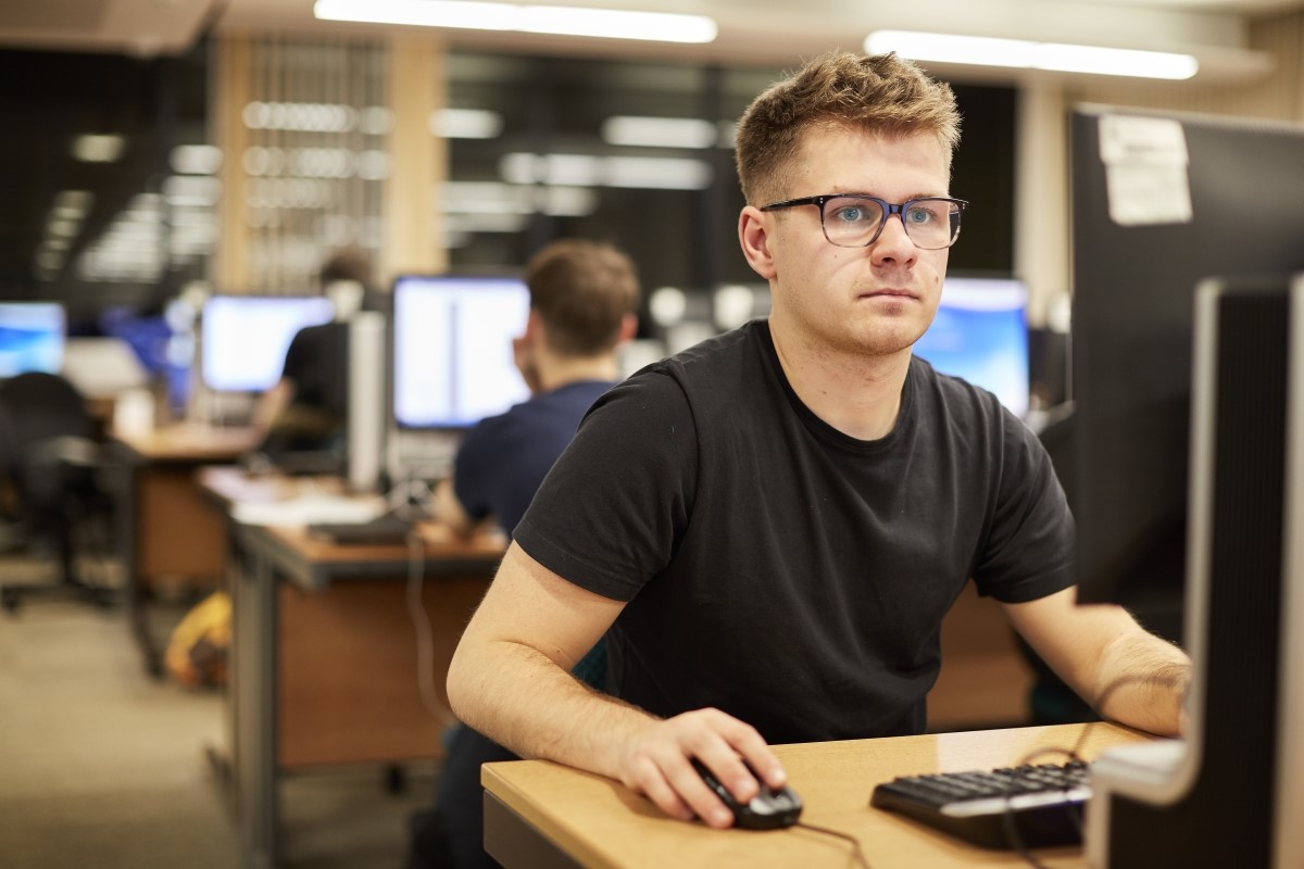 Male student working at a PC