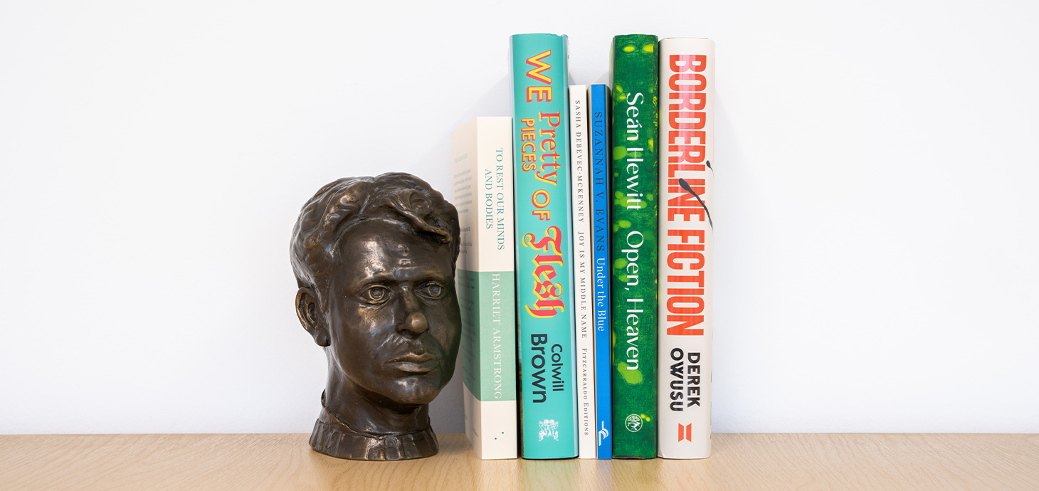 Bookshelf image of the 6 book spines accompanied by bronze bust of Dylan Thomas