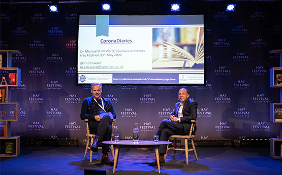 Michael Ward seated onstage at Hay festival