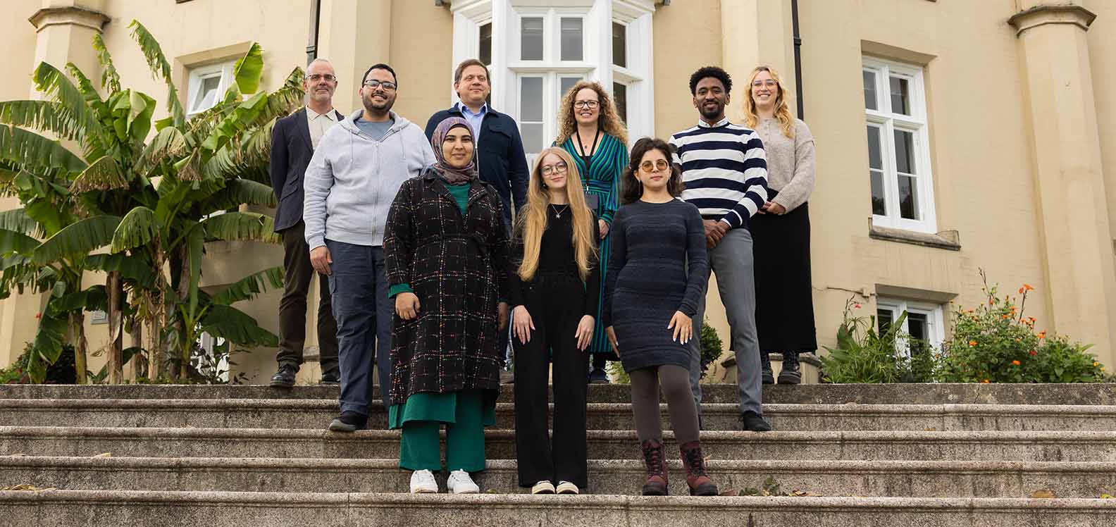 Cynrychiolwyr o Brifysgol Abertawe gyda myfyrwyr rhyngwladol sydd wedi ffoi o'u cartrefi oherwydd gwrthdaro.