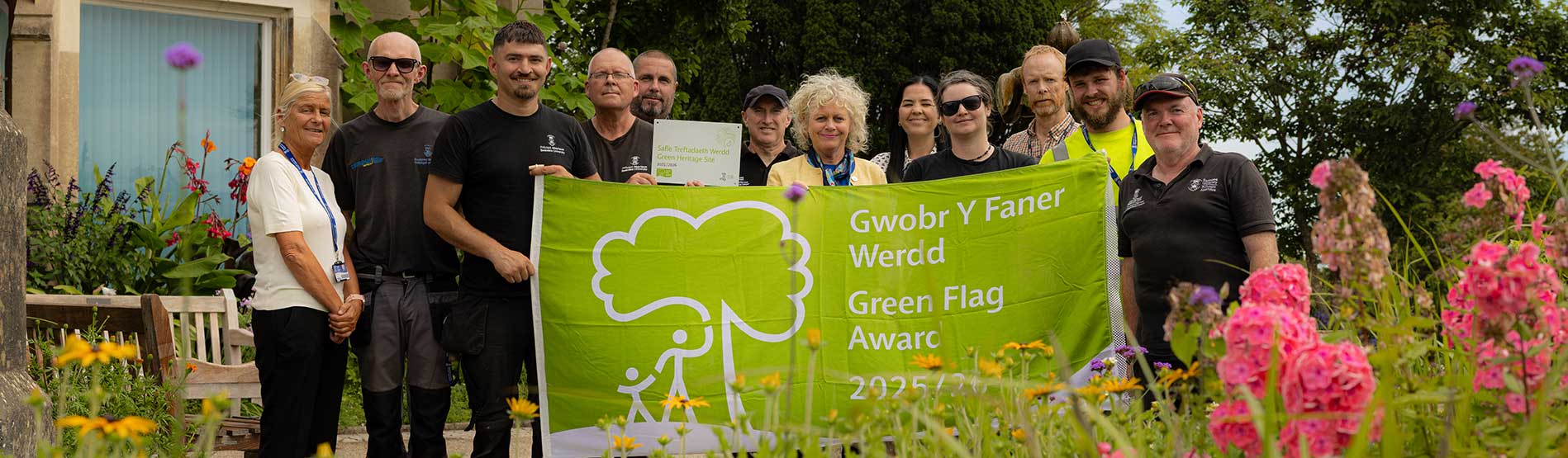 Swansea University's Grounds and Campus Teams with Registrar holding up the 2025 Green Flag 