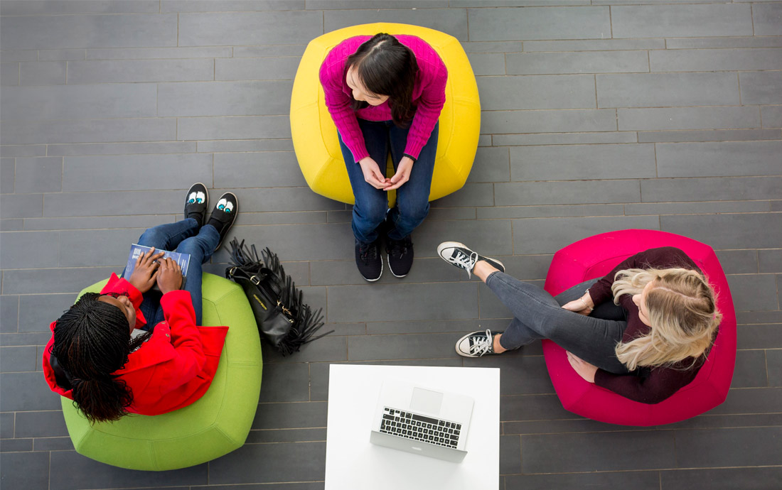 Three students working photographed from above