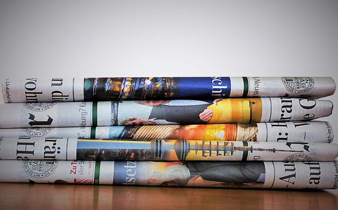 A stack of magazines and newspapers