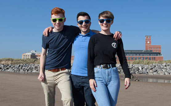 group of students on the beach smiling