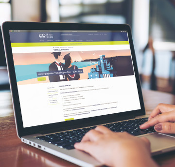 laptop showing swansea uni homepage