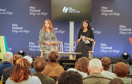 Elaine Canning and Yasmin Zaher sat on the Hay Festival stage with audience in front of them.