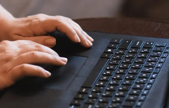 Hands typing on a keyboard