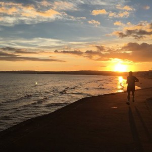 Student on the beach during sunrise