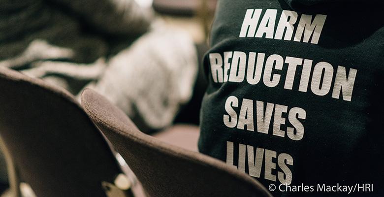 Slogan on shirt Harm reduction saves lives