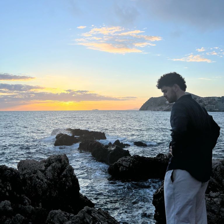 Student standing at shoreline