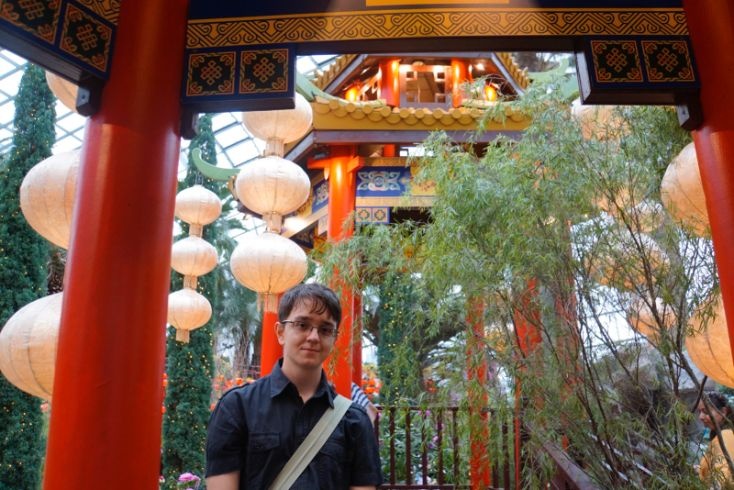 student in front of temple and lanterns