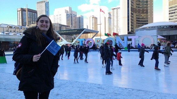 Student with flag ice skating