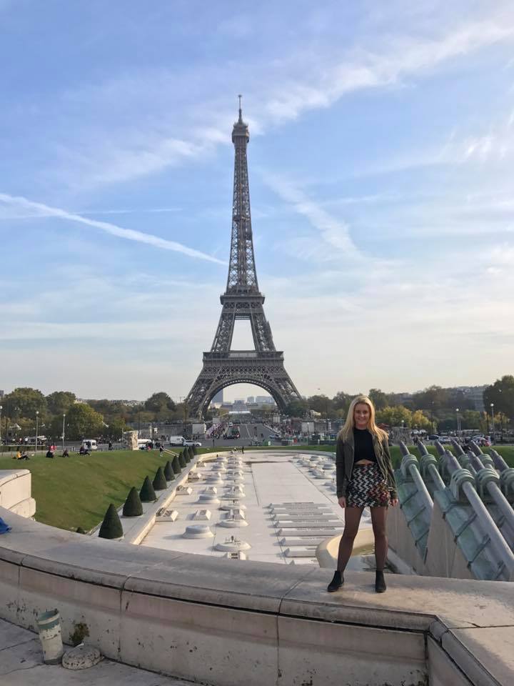 Female student in front of Eiffel Tower in Paris