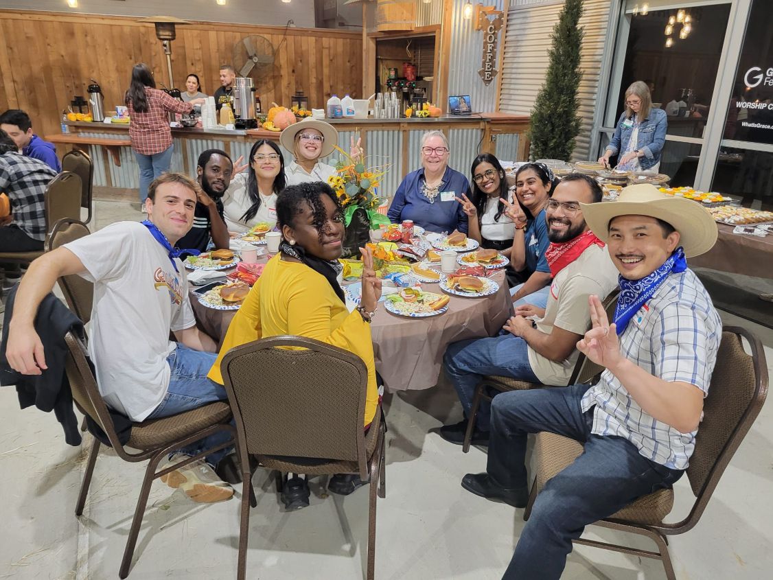 International students sat around a table of food in Houston.
