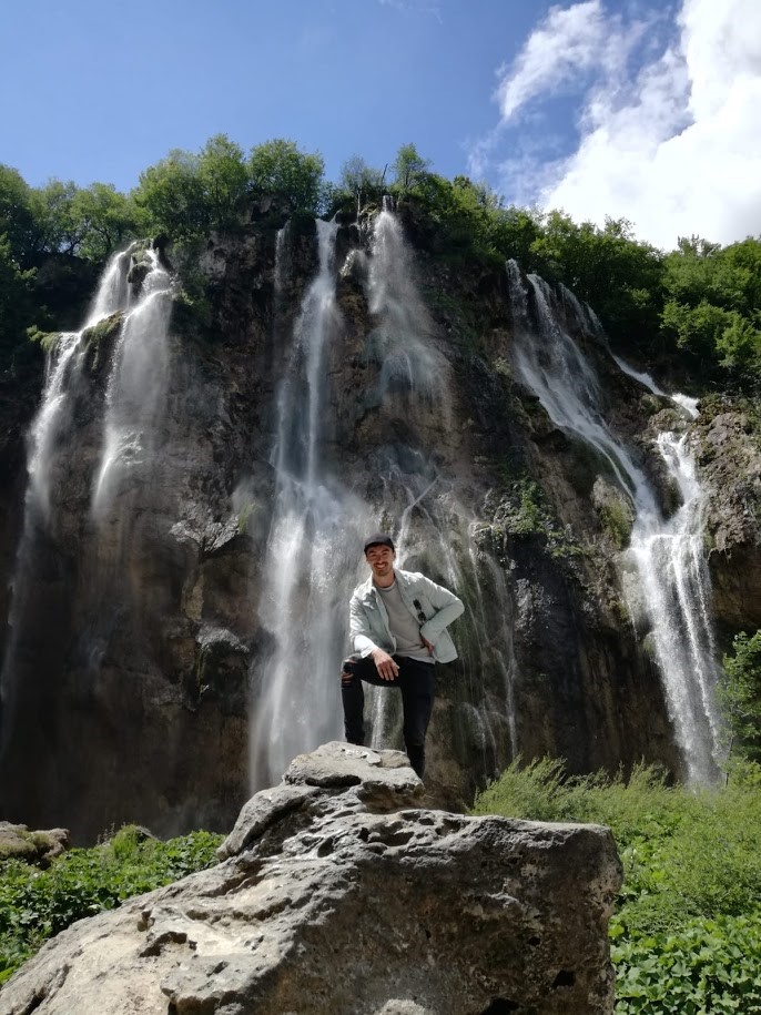 student posing in front of waterfalls in Germany