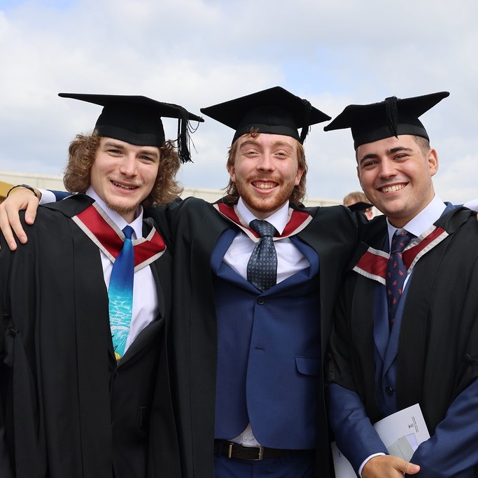 A group of graduates smiling 
