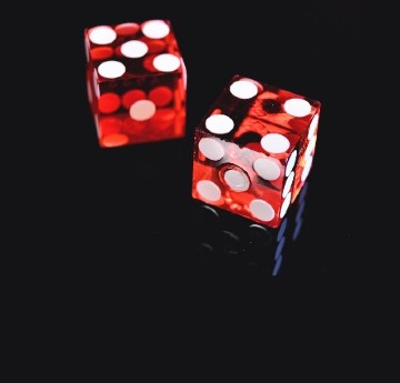 Image of two dice on dark background