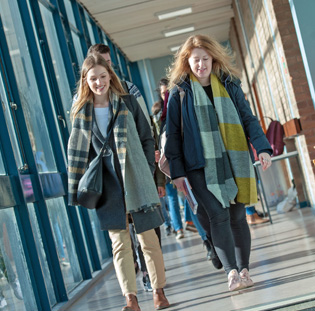 Swansea University students talking and walking