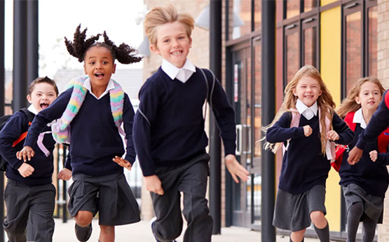 5 children in school uniform running forwards