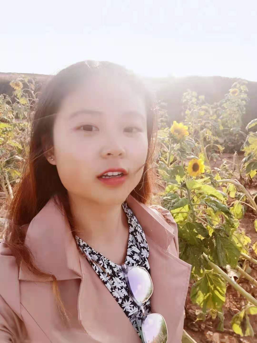student smiling in a field