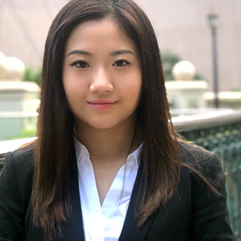 Female student from Hong Kong smiling to the camera wearing smart business clothes