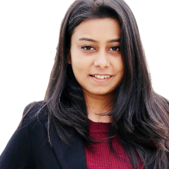 Female Indian student looking at the camera wit a white background.