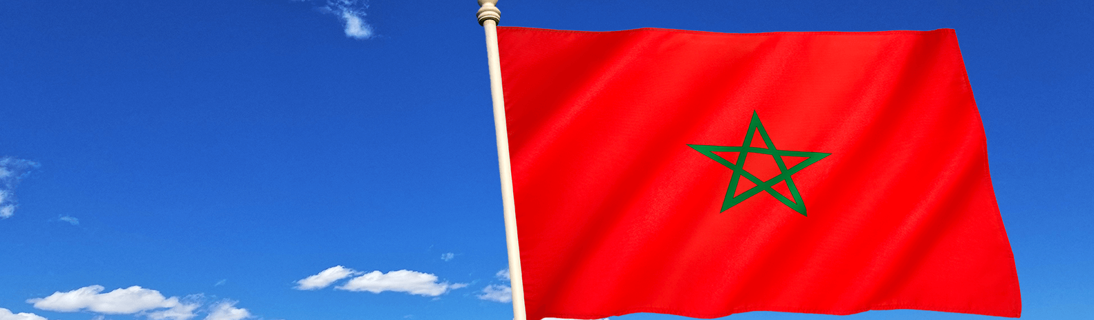 Moroccan flag on the background of the blue sky