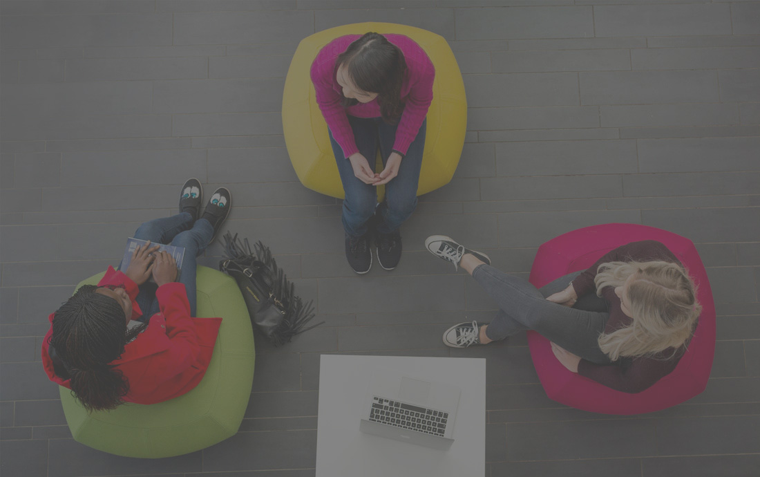 An aerial of three students having a conversation