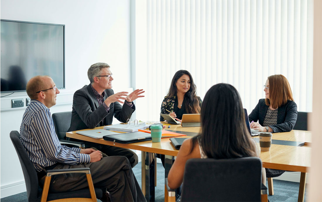 A group of people in a meeting